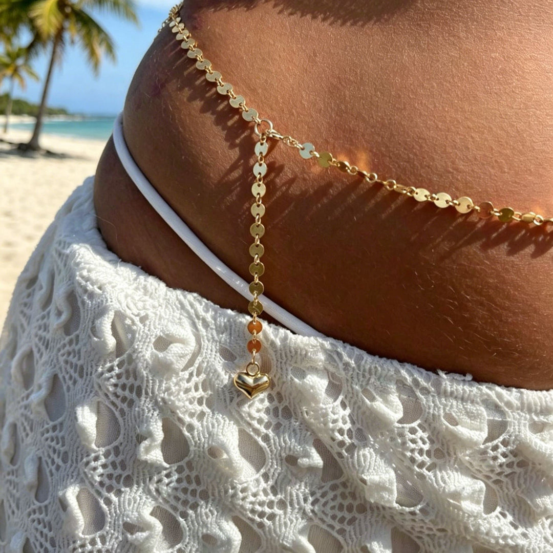 Women's elegant gold body chain, a delicate and fashionable summer accessory for beach and festival outfits.