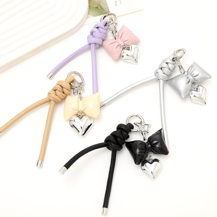 Elegant gold bow & heart keychain, a fashionable bag charm for women.