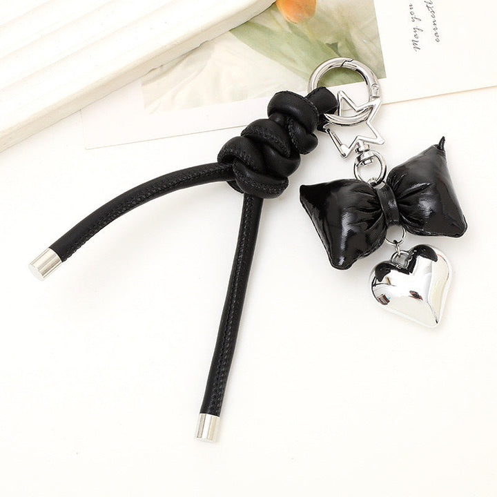 Women's fashionable bow & heart accessory, a versatile bag charm & key holder.