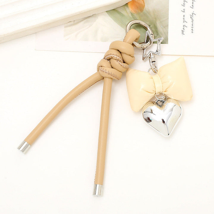 Elegant bow & heart design, a stylish keyring that complements any bag.