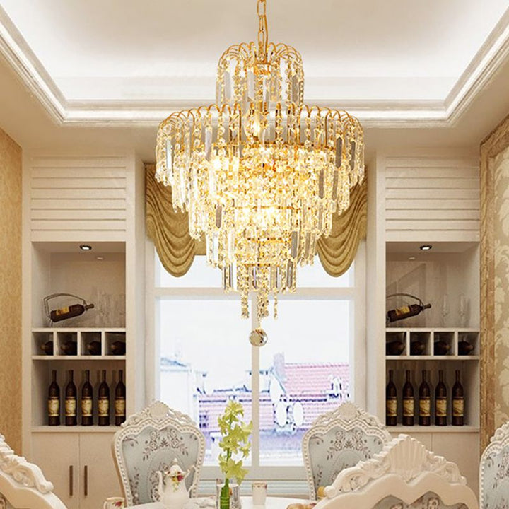 Stunning tiered chandelier with shimmering gold frame & sparkling crystals. Luxury lighting for elegant living rooms.