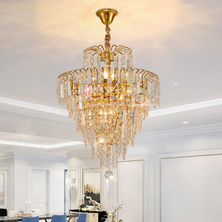 Luxury gold and crystal tiered chandelier, a grand lighting statement. Adds elegance and classic charm to any upscale room.