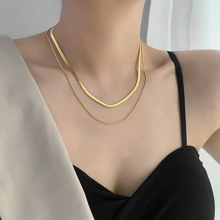 Women's elegant gold snake chain necklace with a double strand layered design, perfect fashion jewelry.