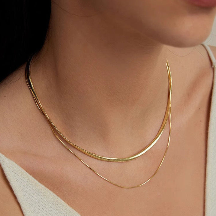Exquisite gold layered double strand snake chain necklace, a sophisticated women's fashion accessory.