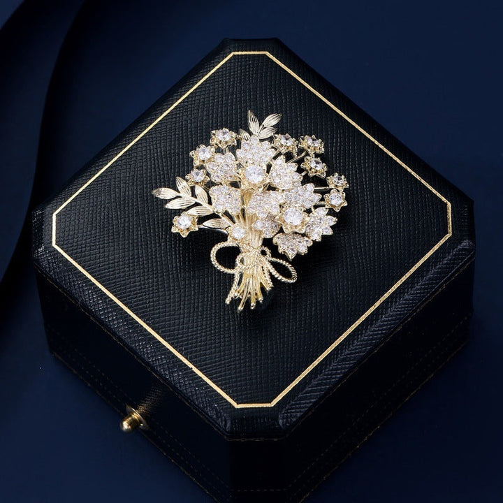 Close-up of a gold floral brooch adorned with brilliant crystals, an exquisite women's elegant accessory.