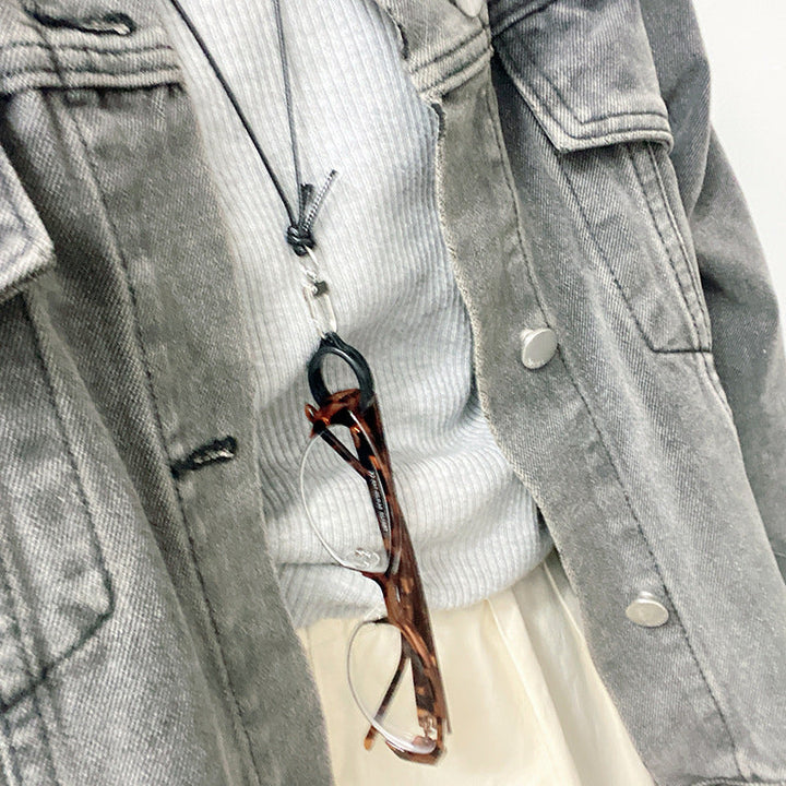 Practical silver spectacle chain keeps reading glasses secure. Stylish and elegant eyewear accessory.