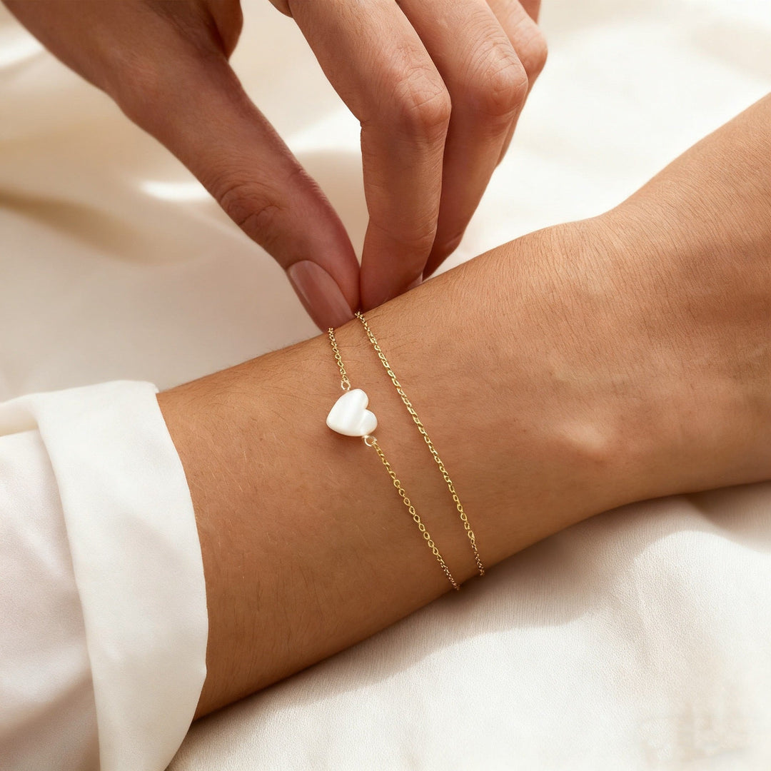 Dainty gold heart charm bracelet, a stackable love symbol. Ideal women's jewelry & anniversary gift.