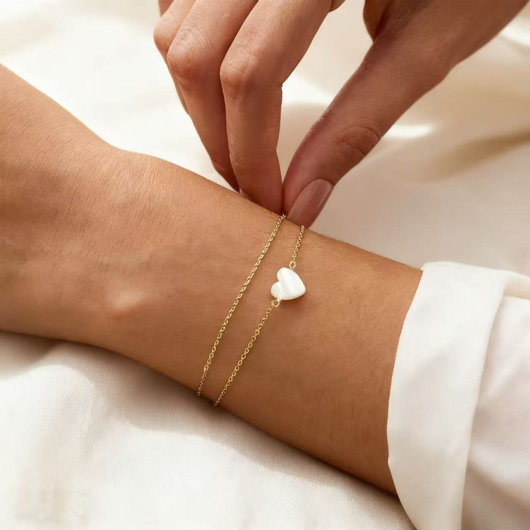 Women's elegant gold bracelet with delicate heart charms. A perfect accessory or anniversary gift.