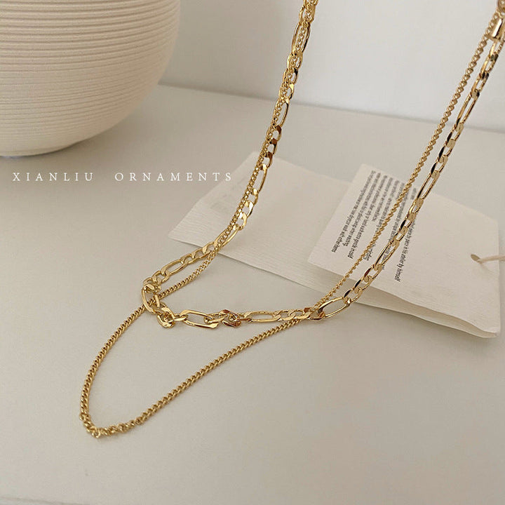 Shimmering gold layered chain necklace, a chic women's fashion jewelry piece for any occasion.