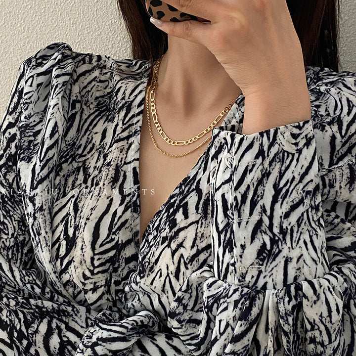 Classic gold layered necklace with delicate chains, an elegant accessory for women's style.