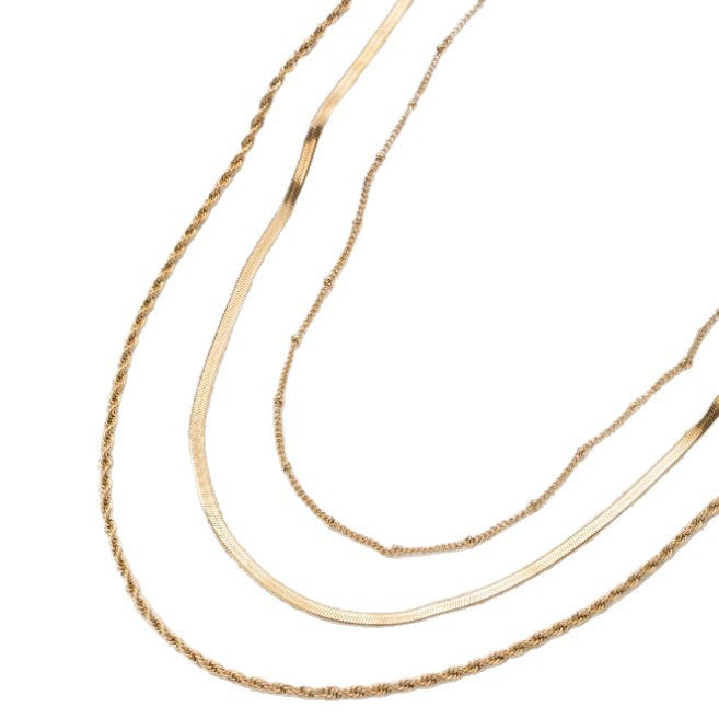 Fashionable gold layered necklace with multiple chains. A versatile women's accessory for everyday elegance.