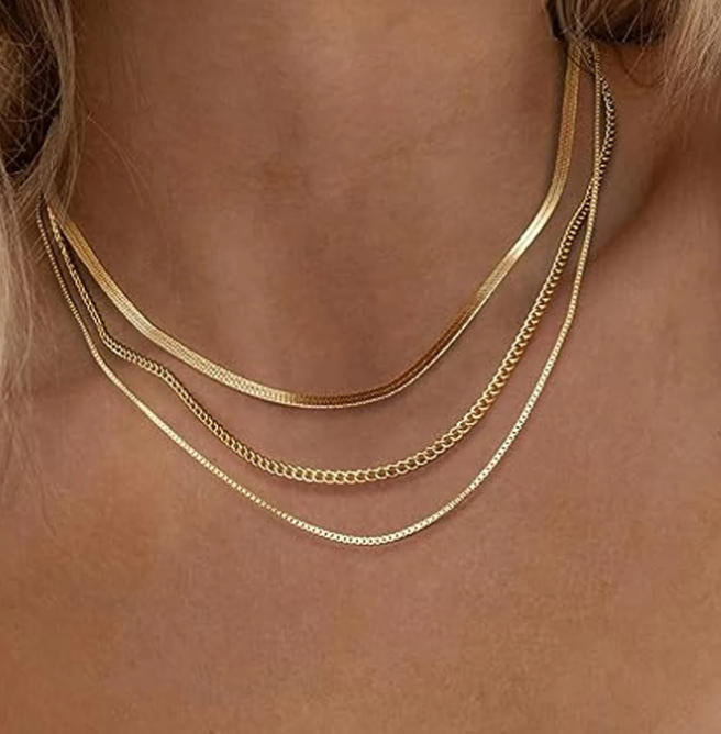 Women's shimmering gold multi-chain necklace. This elegant layered jewelry adds a luxurious touch to any outfit.