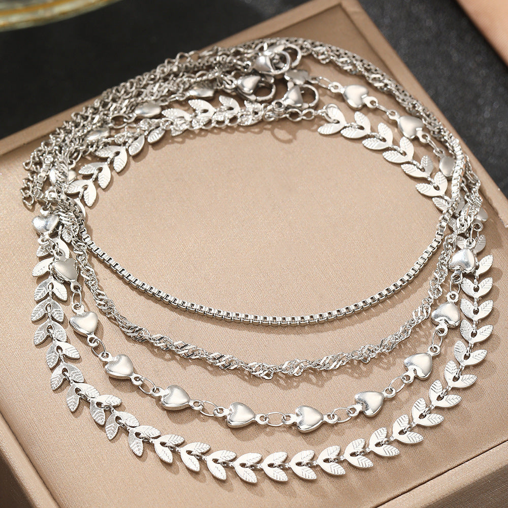 Women's elegant layered gold necklace with heart charms. A chic accessory for any outfit.