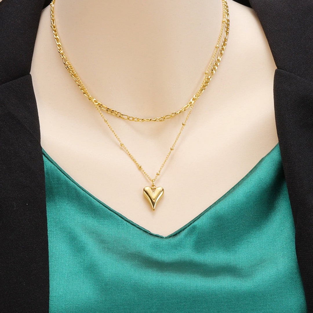 Elegant gold layered necklace with two delicate heart pendants. Perfect women's fashion accessory or gift for her.