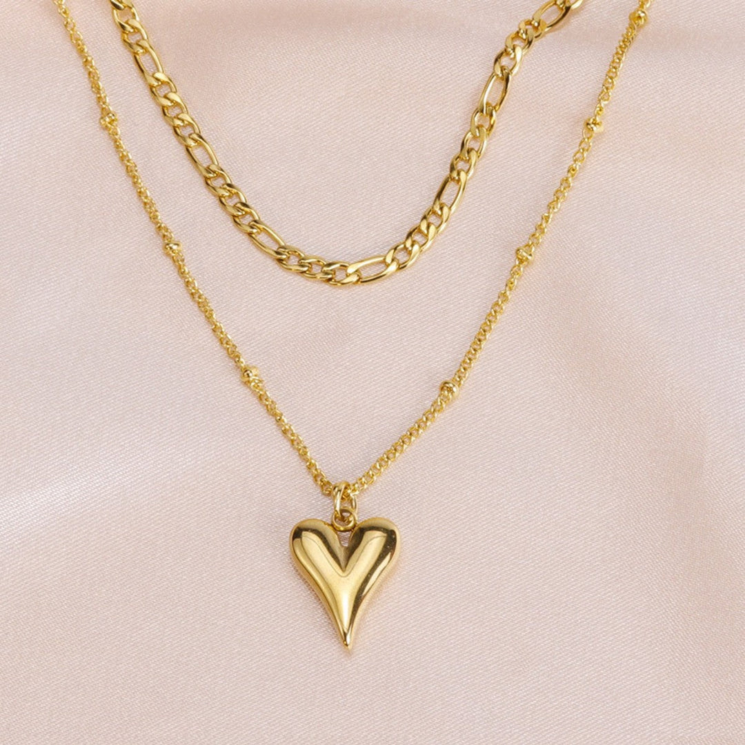 Dainty gold layered necklace for women, featuring a charming heart pendant. Ideal elegant jewelry gift.