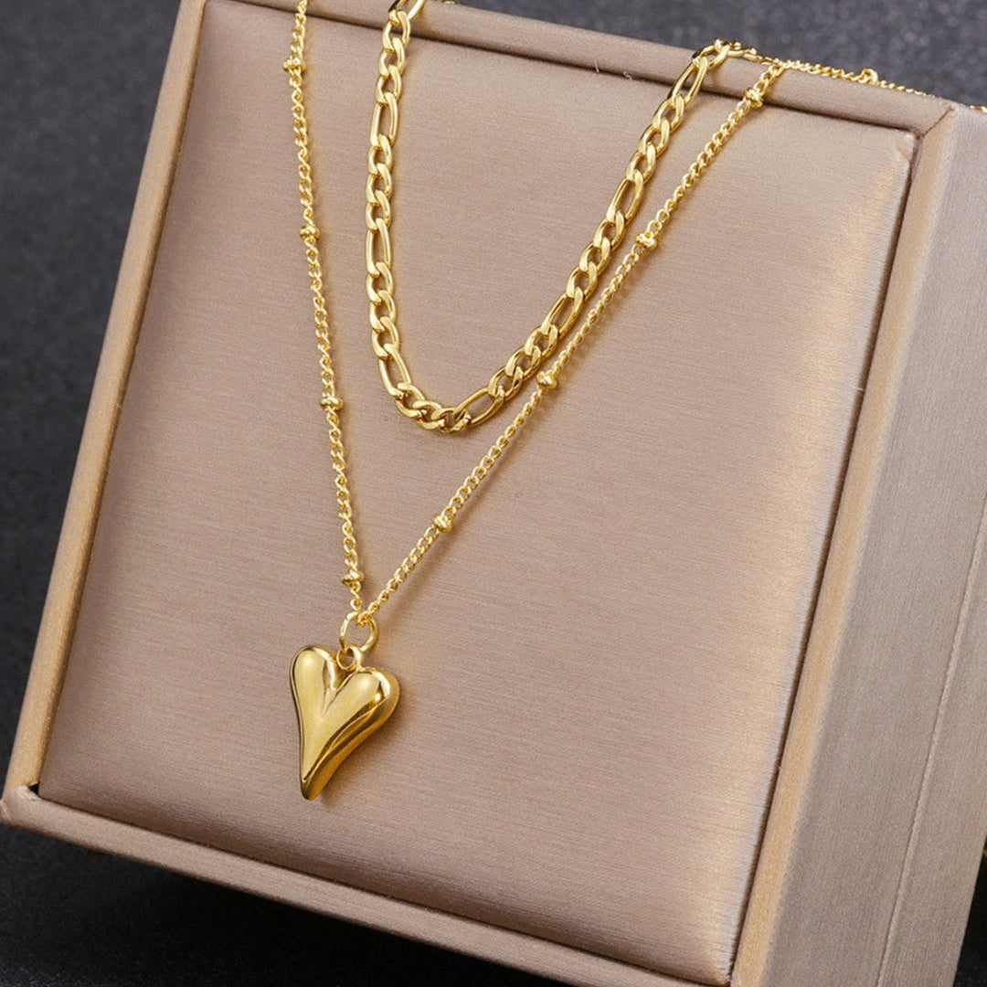 Fashionable layered heart pendant necklace in gold. A beautiful women's jewelry accessory, great gift.