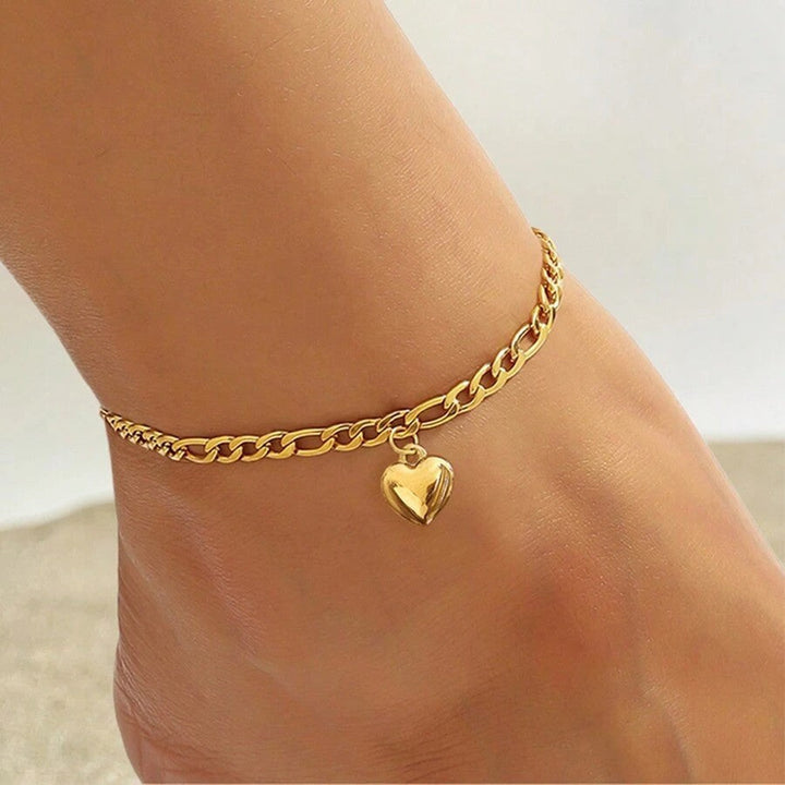 Elegant gold link bracelet for women, featuring a delicate heart charm. Adjustable fashion jewelry.