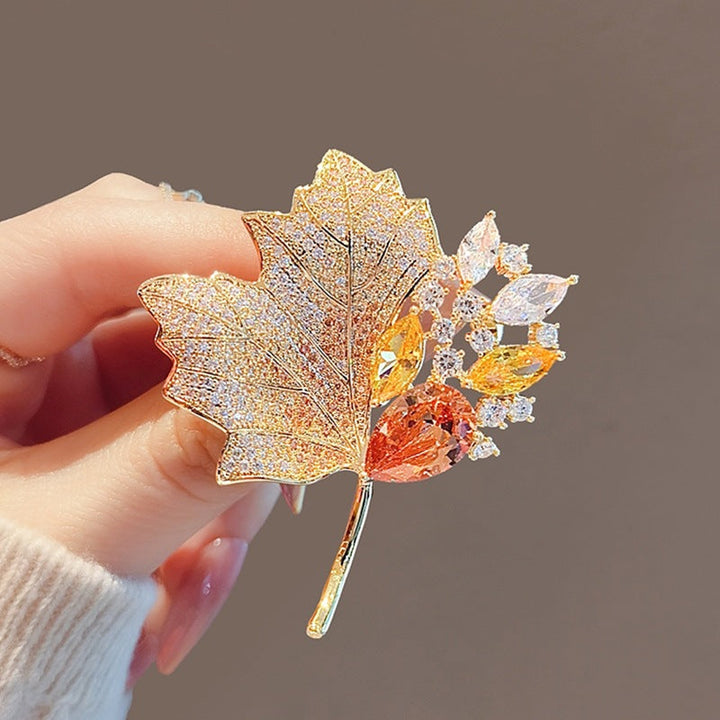 Sparkling crystal leaf brooch pin, gold plated, a chic women's accessory or elegant gift.