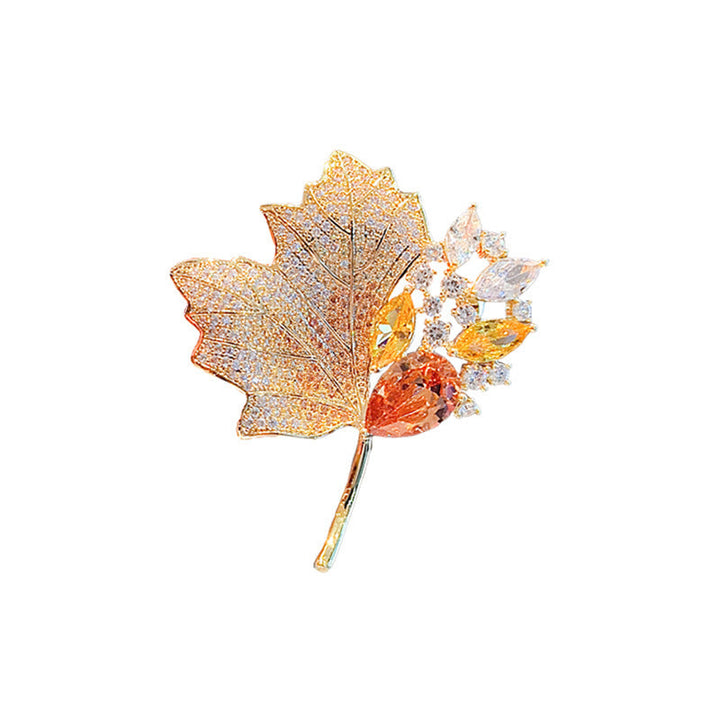 Detailed gold plated leaf brooch with sparkling crystals, an elegant women's nature-inspired accessory.