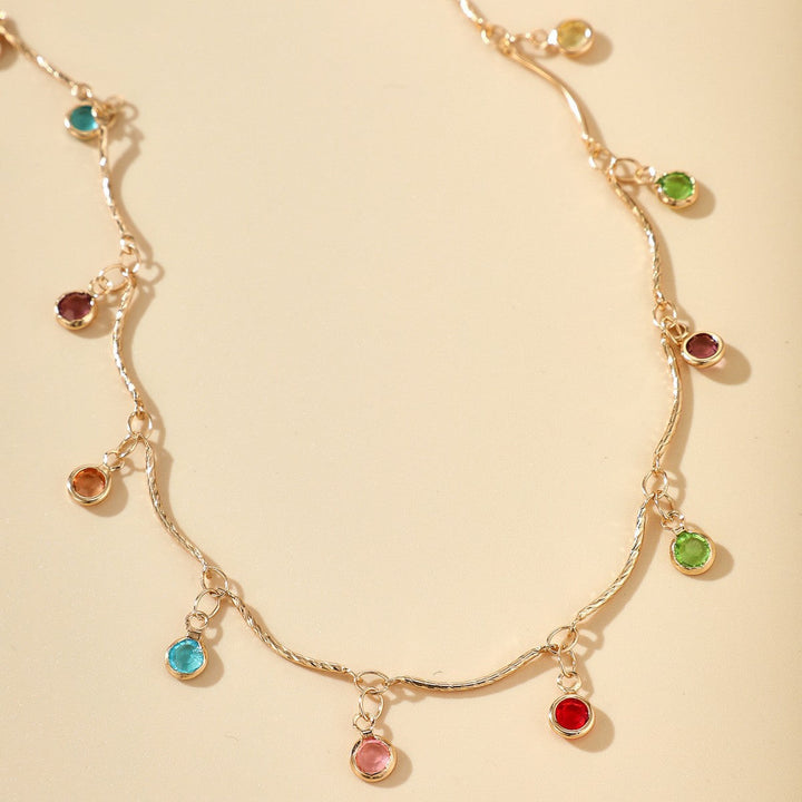 Adjustable gold-plated necklace featuring an array of colorful gemstone charms. Elegant women's fashion jewelry gift.