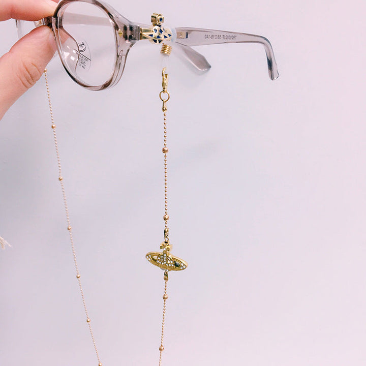 Elegant gold-tone glasses chain with delicate beads. Secure and stylish eyewear accessory for everyday elegance.
