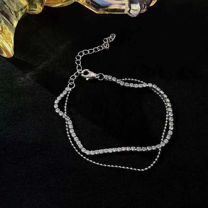 Modern women's double layer anklet. Elegant and minimalist foot chain, a must-have fashion accessory.