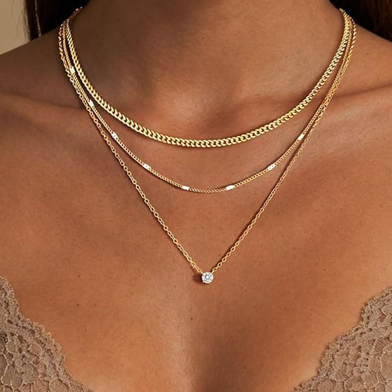 Dainty multi-layered gold chain necklace for women, an elegant fashion accessory. Adjustable women's jewelry.