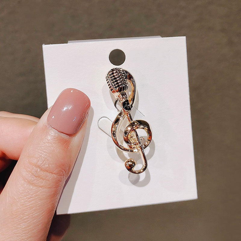 Elegant gold-tone musical note brooch, a stylish lapel pin for music lovers. Unisex fashion accessory gift.