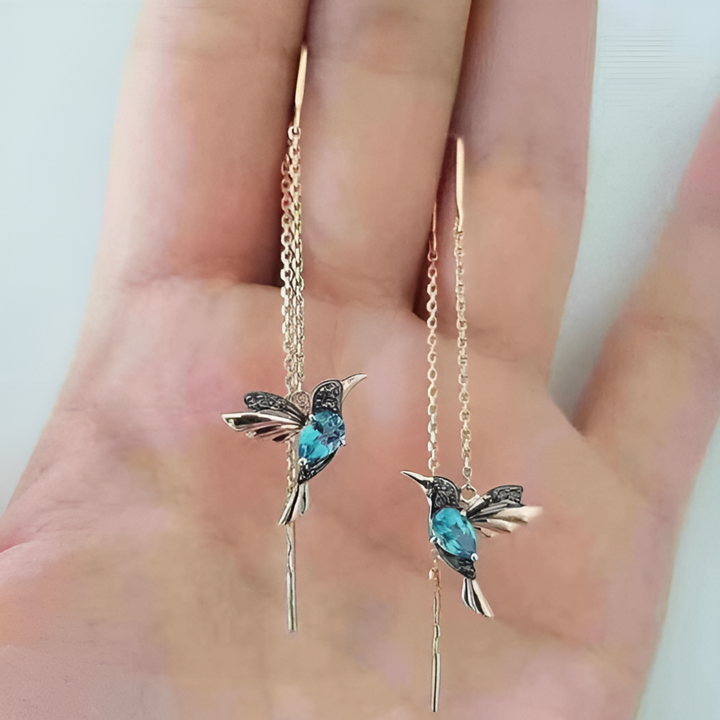 Fashionable women's hummingbird drop earrings, gold tone with sparkling crystal. A chic and whimsical accessory.