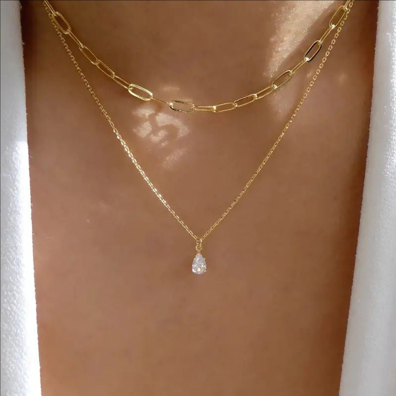 Elegant gold & white layered link chain necklace for women, a stylish fashion accessory.