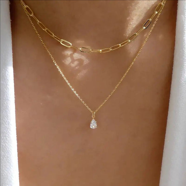 Elegant gold & white layered link chain necklace for women, a stylish fashion accessory.