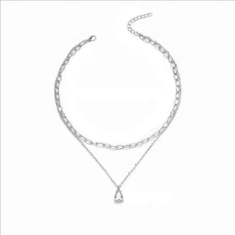 Luxury women's layered gold necklace with white accents, a sophisticated addition to your look.