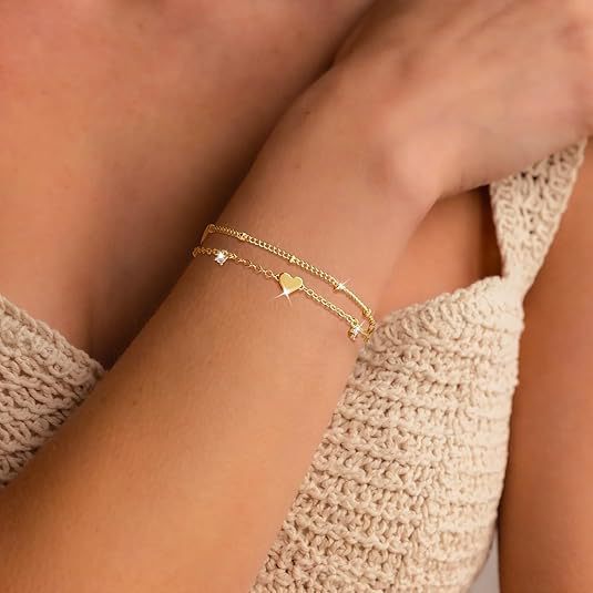 Elegant gold women's bracelet with delicate heart & star charms. Adjustable chain fashion accessory.