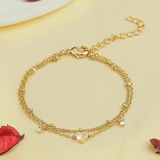 Chic women's gold bracelet, elegant heart & star charms. Perfect delicate fashion accessory.