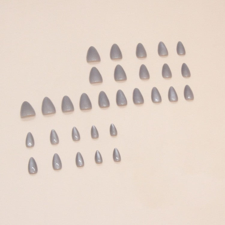 Stunning gray stiletto press-on nail tips, an elegant and easy beauty accessory for women's nail art.