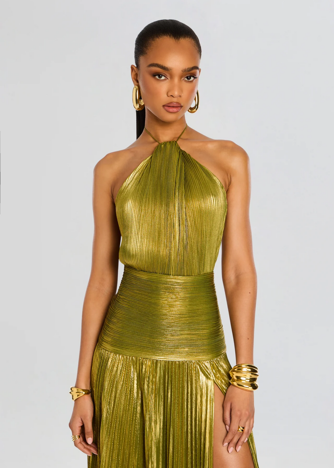 Chic women's halter neck maxi dress in green with an elegant thigh split. Ideal as a formal evening gown.