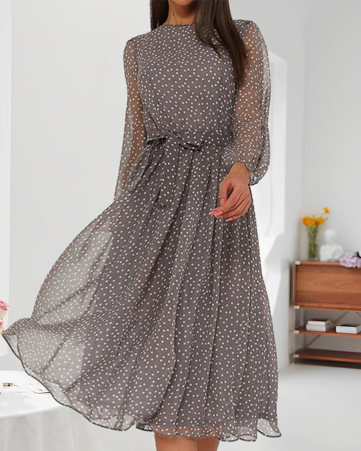 Stylish women's knee-length A-line dress in grey with polka dots, long sleeves, ideal for an elegant casual look.