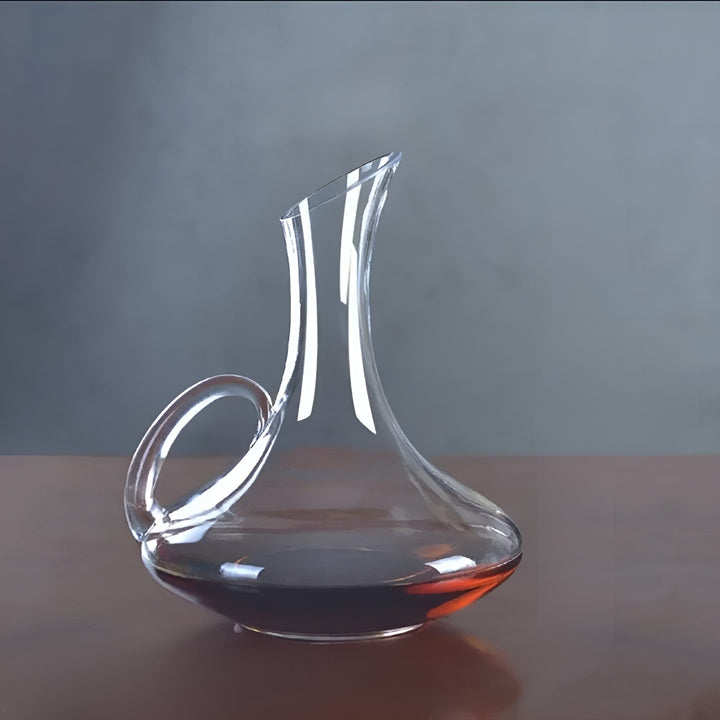 Stylish crystal wine decanter on a dining table, handmade, designed to beautifully aerate and serve fine wines.
