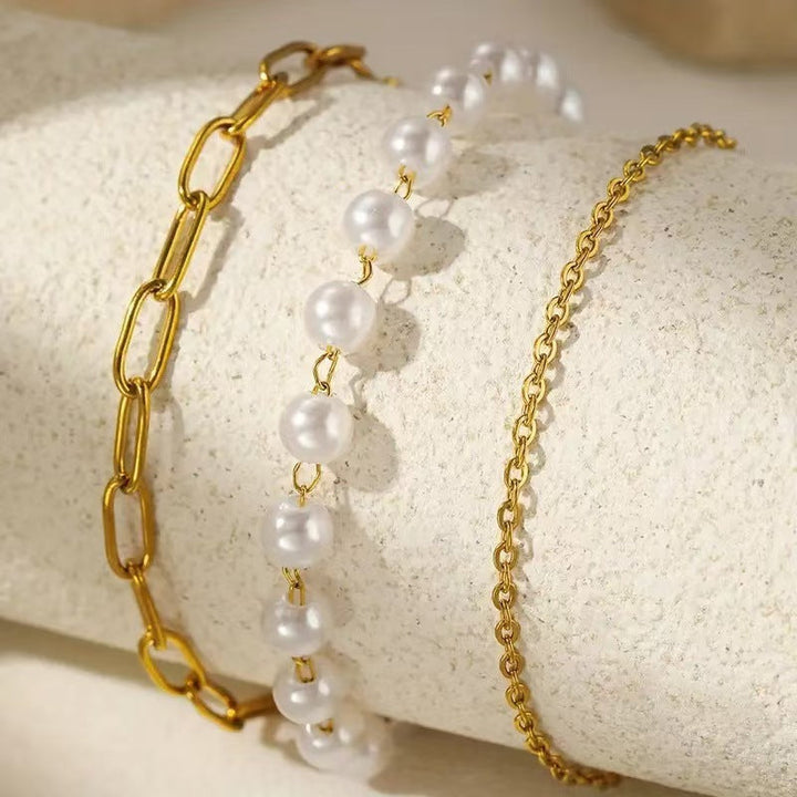 Gift for her: Elegant women's layered bracelet set with lustrous pearls & stylish chains. A timeless accessory.