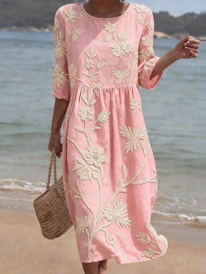 Women's flowy midi dress with elegant embroidery, relaxed fit, three-quarter sleeves. Light pink.