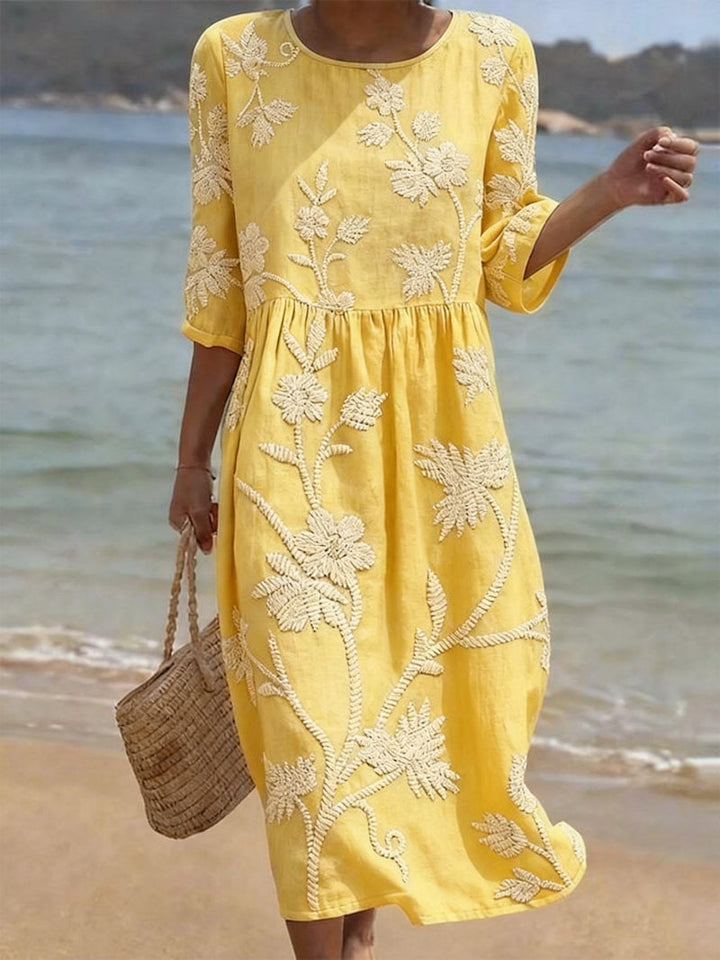 Light pink embroidered midi dress for women, relaxed fit, flowy style, three-quarter sleeves. Occasion wear.
