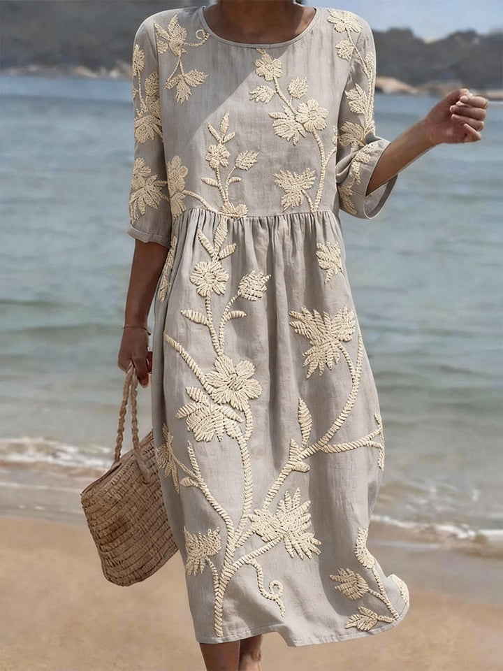 Women's elegant light blue midi dress, relaxed fit, embroidered details. Comfortable spring/summer occasion wear.