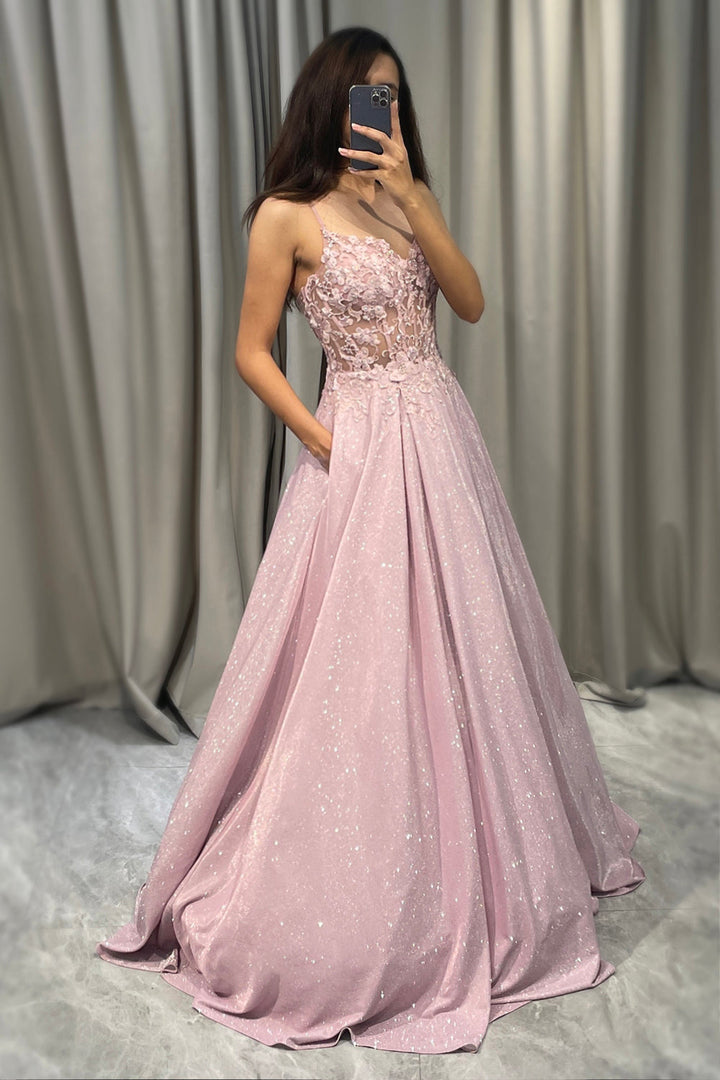 Model wears a flowing light pink embellished maxi dress, a chic and elegant choice for a wedding guest or special occasion.
