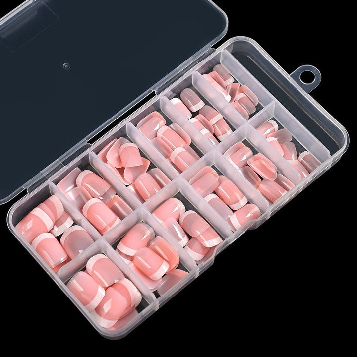 Women's elegant light yellow French tip false nails. Glue-on artificial nails kit for a chic and quick beauty manicure.