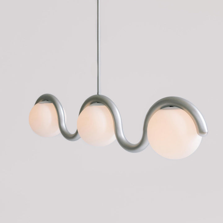 Elegant metal & glass linear light, adjustable pendant for modern kitchen islands.