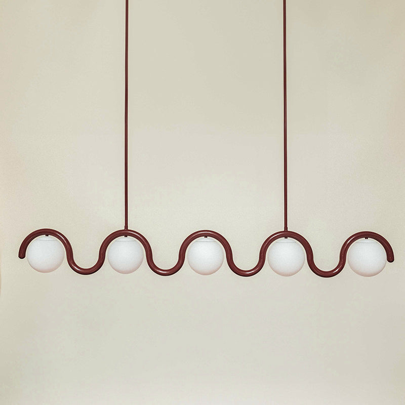 Adjustable elegant linear pendant, modern glass & metal light for a refined living space.