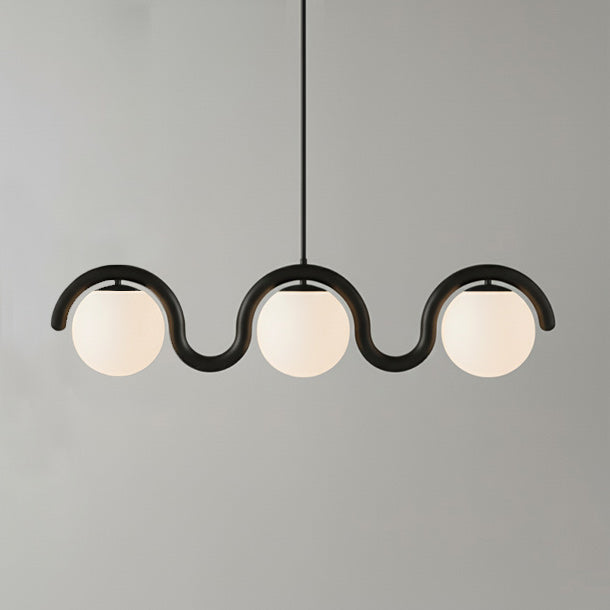 Adjustable linear glass & metal pendant, elegant design for modern dining spaces.