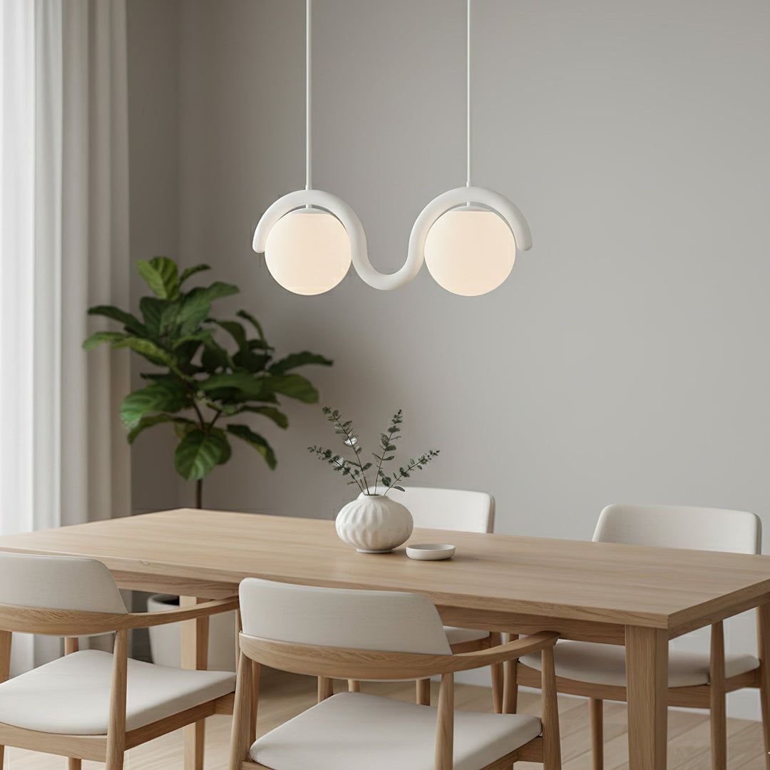 Sleek linear pendant light, glass & metal for contemporary dining.