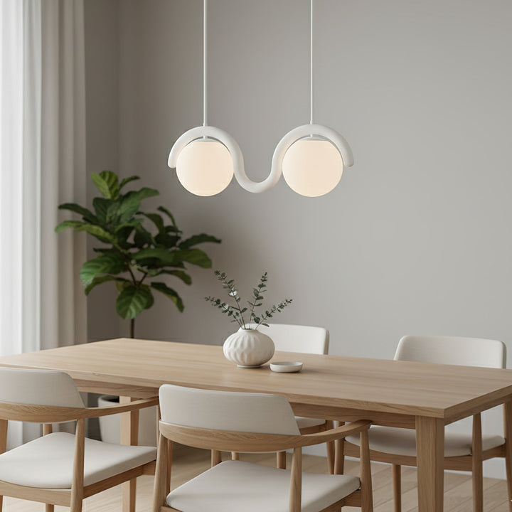 Sleek linear pendant light, glass & metal for contemporary dining.