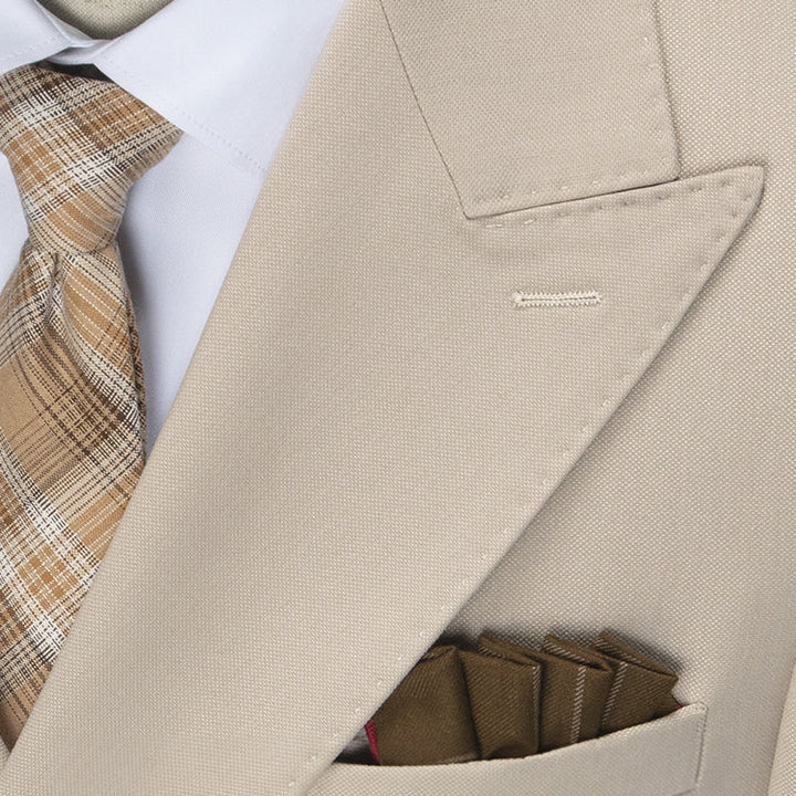 Close-up of a men's double-breasted suit showing its classic peak lapel & button detailing, perfect for weddings.